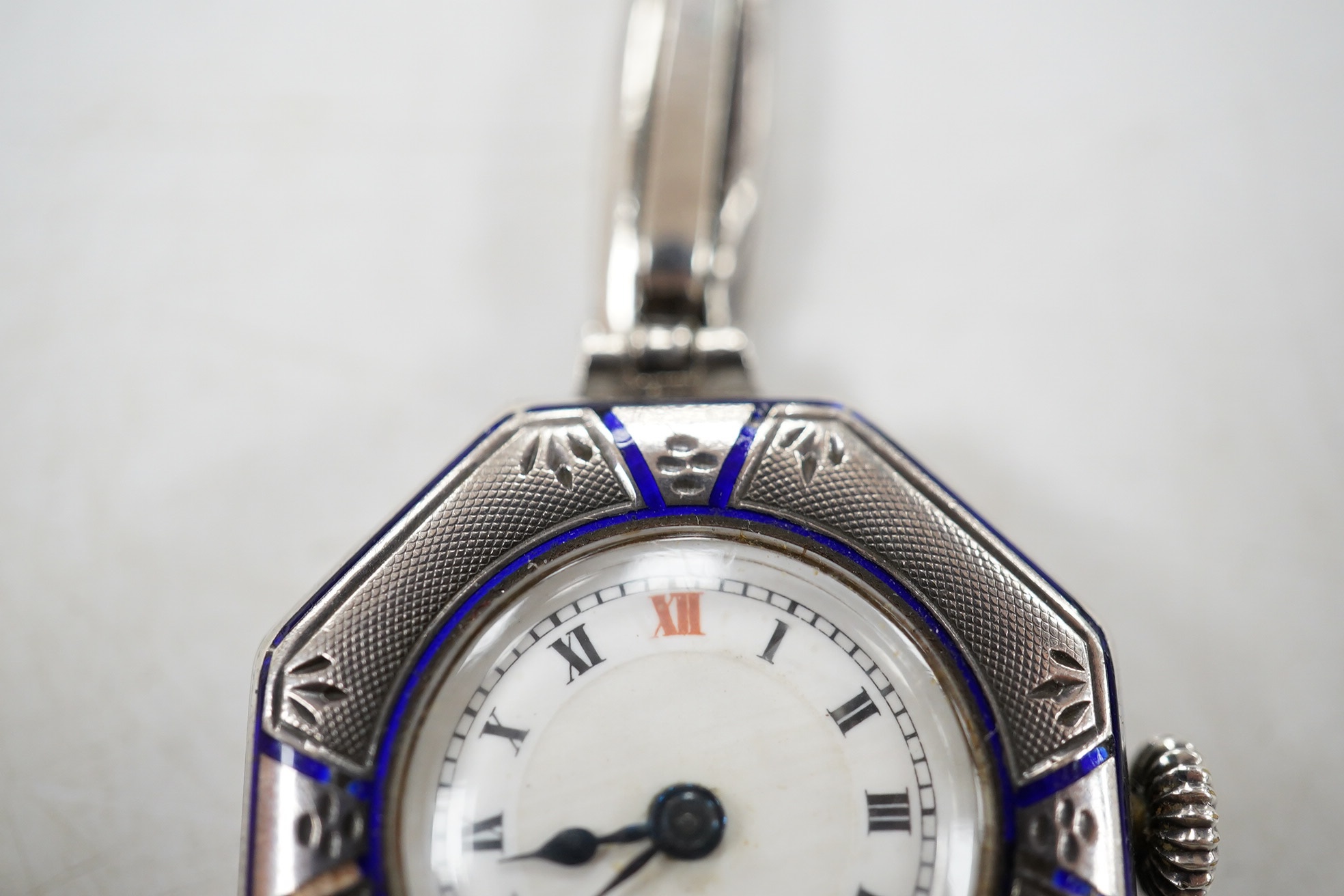 A lady's early 20th century continental sterling and enamel octagonal manual wind wrist watch, on a sterling expanding bracelet, 16.8cm. Condition - poor to fair